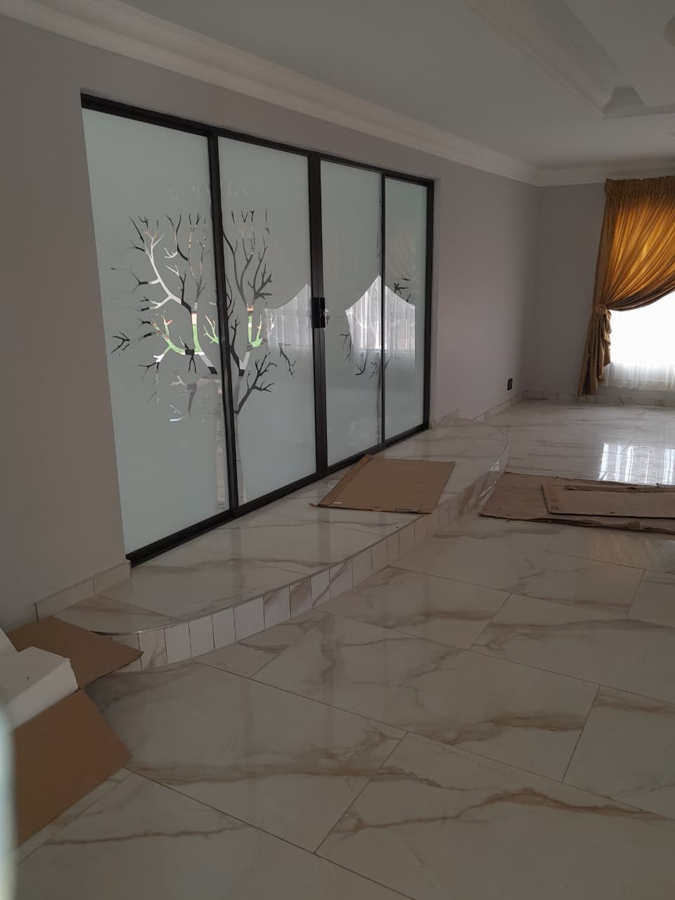 Aluminium sliding glass doors with a sandblasted tree design