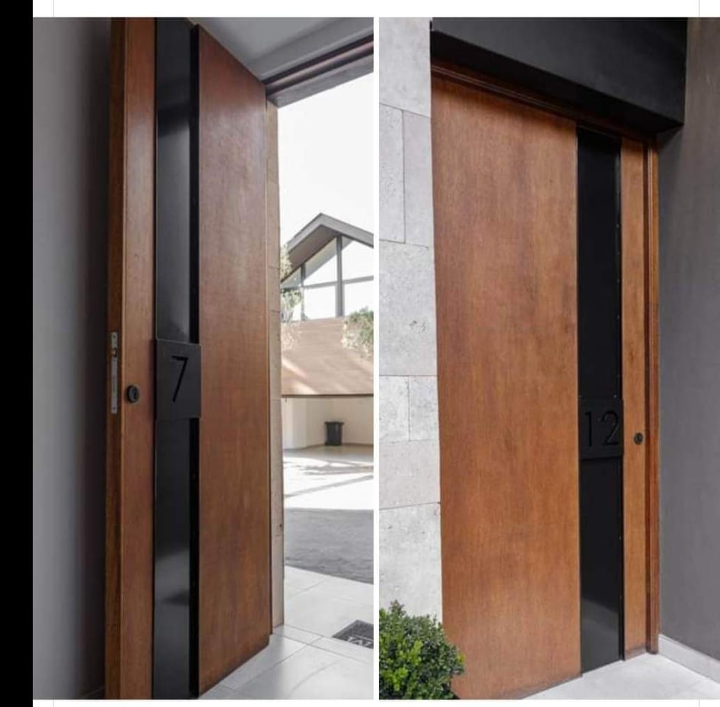 A pair of matched timber pivot entrance doors