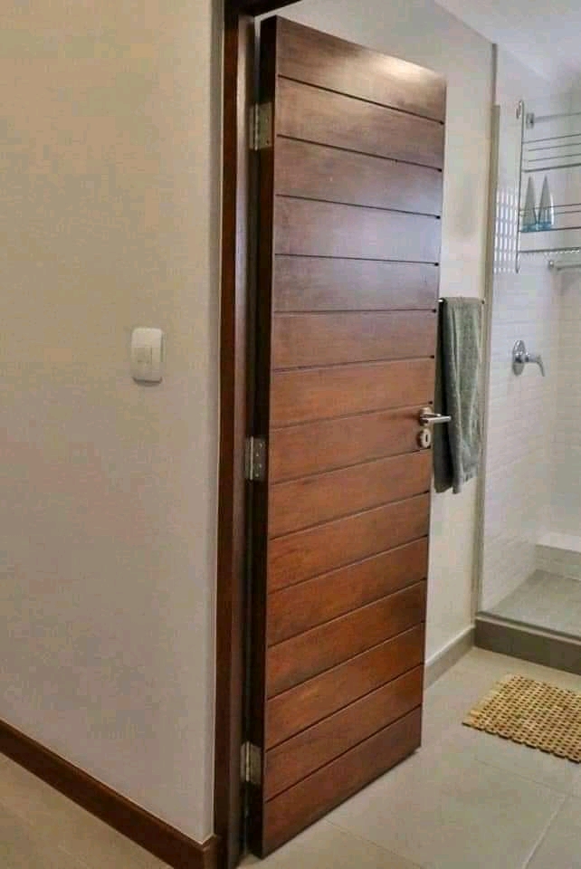 Dark-stained timber slat interior door